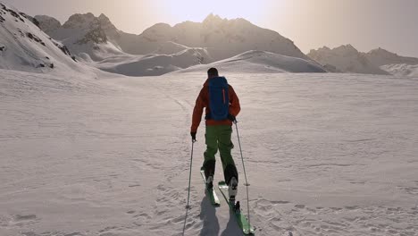 Lonely-ski-guide-hiking-to-the-top-of-the-mountain