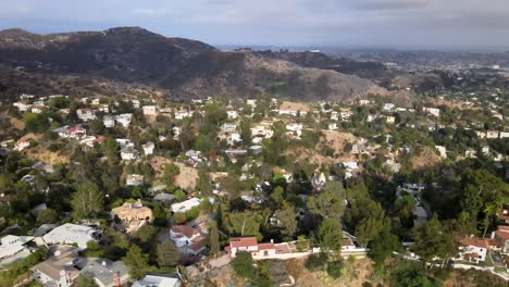 Aerial-view-flying-across-vast-residential-urban-real-estate-Hollywood-countryside-mountain-landscape-dolly-right