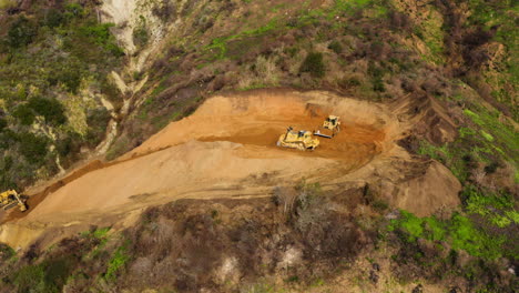 Earthmoving-Machine-Driving-On-Rural-Dirt-Road-At-Rat-Creek-Washout,-Big-Sur,-Us,-Aerial