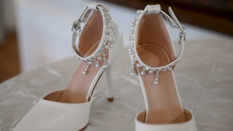 Close-up-circling-view-of-luxurious-bridal-shoes-on-wedding-day