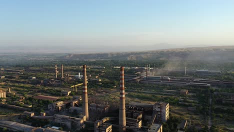Aerial-View-Of-Chimneys-Of-An-Abandoned-Soviet-Factory-In-Ghost-Town-Of-Akarmara-In-Tkvarcheli,-Georgia