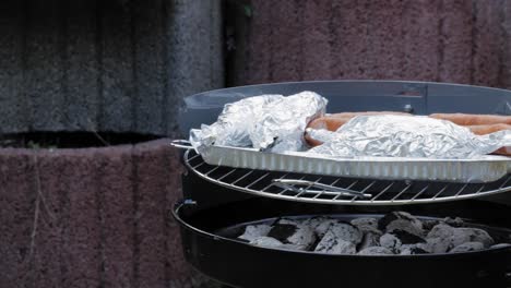 Cooking-On-The-Big-Round-BBQ-Grill-Outdoors---panning-shot