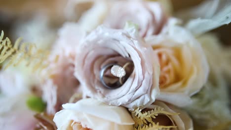 Wedding-Rings-Placed-In-Flower-Arrangement---Close-Up-Shot