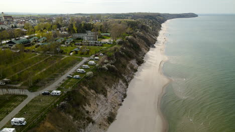 Many-Camper-trailers-in-the-camping-area-on-the-rocky-beach-near-the-Baltic-Sea-in-Władysławowo,-Poland