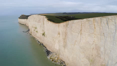 Aerial-shot-flying-along-with-the-seven-sisters-on-the-south-coast-of-England-in-East-Sussex-with-huge-white-chalk-cliffs,-near-Eastbourne