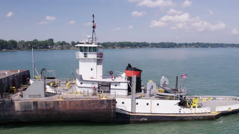 Gravel-Ship-Traveling-Lake-Erie-With-Green-Trees-At-The-Waterfront-In-Ontario,-Canada