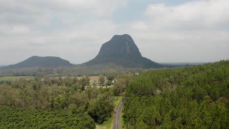 Lush-Green-Vegetation-And-Scenic-Hills-At-Glass-House-Mountains-On-Sunshine-Coast-Region,-Queensland,-Australia---aerial-shot