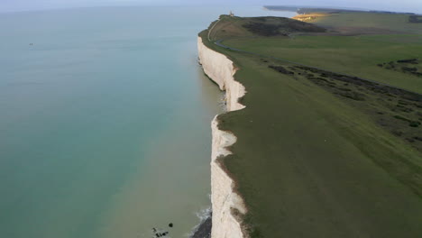 Aerial-shot-flying-along-with-the-seven-sisters-on-the-south-coast-of-England-in-East-Sussex-with-huge-chalk-cliffs,-near-Eastbourne