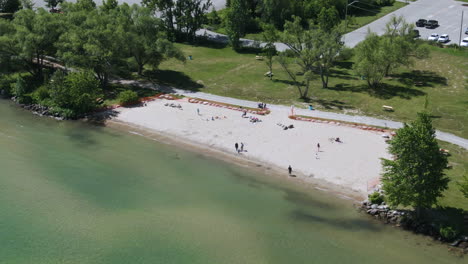 Aerial-high-angle-shot-of-people-relaxing-at-Innisfil-beach-in-Lake-Simcoe-coast
