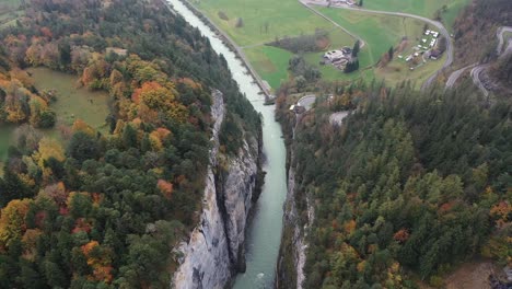 Epic-Aerial-Flight-Over-Mist-Forest-Colorful-Autumn-Trees-and-Beautiful-blue-canyon-river-in-autumn-forest,-top-view