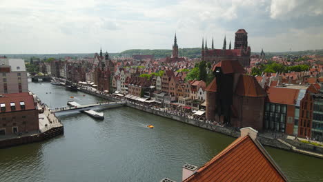 Gdansk,-Old-town---Drone-Flying-Over-Kladka-na-Wyspe-Spichrzow,-Sky-Bar-Hotel,-Nova-Motlava-river-and-reviling-beautiful-polish-architecture-of-Old-Gdansk-which-is-tourist's-travel-spot