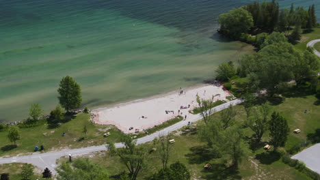 Aerial-high-angle-view-of-Innisfil-beach-surrounded-by-trees-on-Lake-Simcoe-coastline