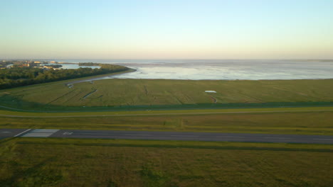 Coastal-Airport-With-Empty-Runway-Through-Fields