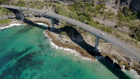 Bird's-Eye-View-Of-Sea-Cliff-Bridge-With-Several-Vehicles-Driving-Across-Grand-Pacific-Drive-Near-Wollongong,-NSW-Australia