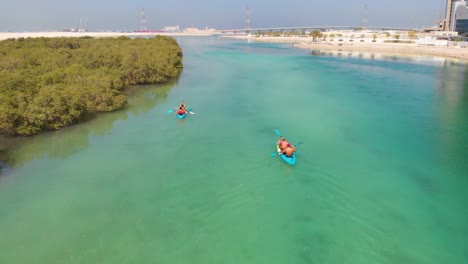 Unrecognizable-people-kayaking-in-turquoise-waters-of-Al-Reem-mangroves
