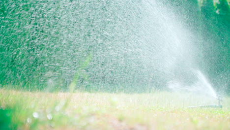 Rotating-automatic-sprinkler-over-the-lawn,-modern-irrigation-device-or-system-to-the-watering-garden