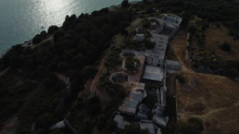 Cinematic-aerial-view-drone-above-a-historic-World-War-I-fort-fortress-fortification-by-the-idyllic-Adriatic-mediterranean-sea-ocean-seaside-with-blue-water-and-hidden-beaches-by-sunset-in-summer