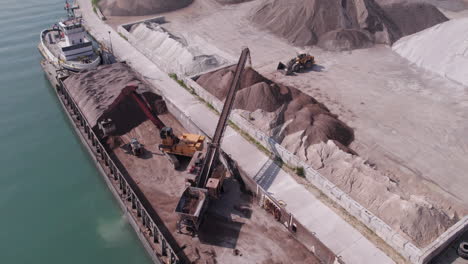 Aerial-View-Of-A-Heavy-Machine-Loading-Gravel-In-Sliding-Machinery-In-Kingsville-Harbour