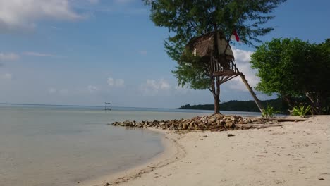 Woman-in-summer-hat-on-the-beach-enjoying-and-playing-on-a-swing-at-Karimun-Jawa