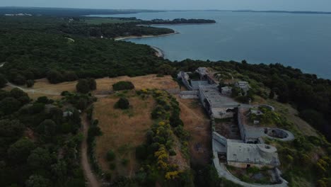 Cinematic-aerial-view-drone-descend-at-historic-World-War-I-fortification-seaside-fort-fortress-by-the-idyllic-Adriatic-mediterranean-sea-ocean-with-blue-water-and-hidden-beaches-for-travel-in-summer