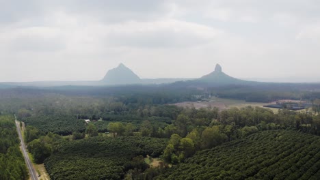Mount-Coonowrin-And-Mount-Beerwah-Obscure-By-Thick-Fog-In-The-Morning-In-The-Glass-House-Mountains-Range-In-Sunshine-Coast-Region,-QLD,-Australia