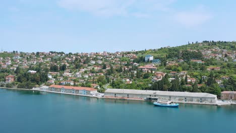 Aerial:-Slovenian-Piran-town-on-Adriatic-coast,-boat-at-local-harbour