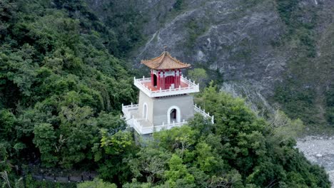 Aerial-orbit-shot-of-Pagoda-temple-at-Taroko-national-park-surrounded-by-green-forest-trees-in-Taiwan,Asia