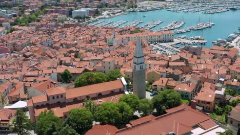 Aerial-shot-flying-over-the-city-of-Izola,-Slovenia-pulling-away-from-the-St