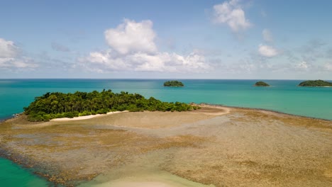 4K-Time-lapse-Aerial-Drone-Footage-Static-Shot-of-Islands-at-low-tide-with-Blue-Skies,-moving-clouds-and-Turquoise-Waters-in-Tropical-Paradise