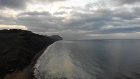 Aerial-View-Of-Cliffs-Along-Charmouth-Beach-With-Morning-Clouds
