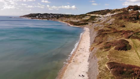 Aerial-View-Of-Charmouth-Beach-And-Cliffs-With-Turquoise-Waters-In-Dorset