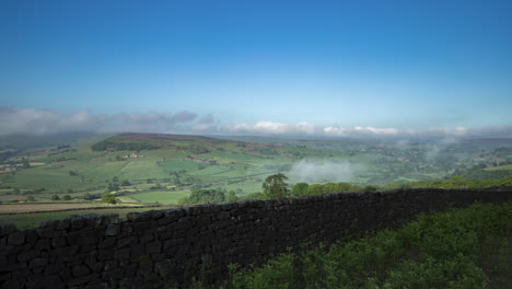 North-York-Moors-Oakley-Wall-Static-Time-Lapse,-looking-across-valley-towards-Castleton,-with-mist-in-valley-evaporating-in-morning-sun