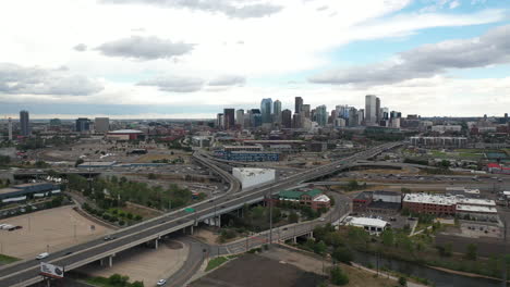 Aerial-View-of-Freeway-Traffic-Outside-Downtown-Denver,-Colorado-USA-Under-Dramatic-Sky,-Drone-Shot