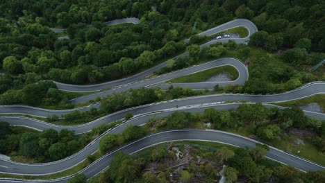 Flying-circle-at-the-idyllic-mountain-serpentine-road-Plöckenpass-in-the-natural-Austrian-and-Italian-alps-in-summer-with-green-forest-trees-and-cars-on-the-street