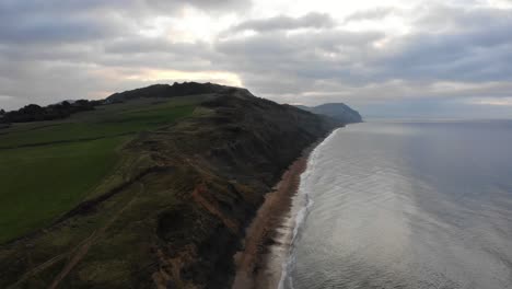 Aerial-View-Along-Cliffs-Along-Charmouth-Beach-In-The-Morning