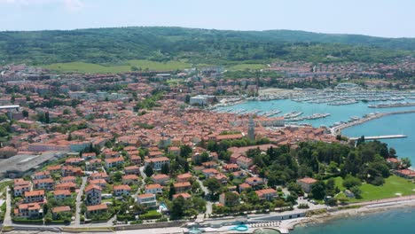 Aerial-arc-dolly-shot-over-the-city-of-Izola,-Slovenia-pulling-up-on-St