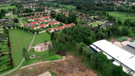 Construction-Site-in-Lush-Villa-Area,-Aerial-Backward