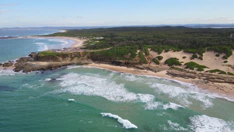 Ocean-Waves-On-Sandy-Shore-Of-Pebbly-Beach-With-Soldiers-Beach-In-The-Distance---Wyrrabalong-National-Park-From-Norah-Head,-NSW,-Australia