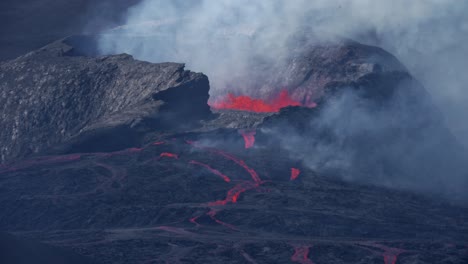 Slow-Motion-wide-shot-of-spewing-volcano-crater-spewing-red-fire-lava