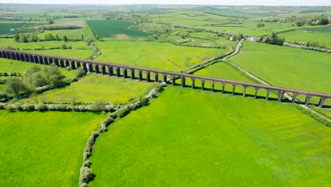 Aerial-View-Of-Welland-Viaduct-Over-Green-Fields-At-Daytime-In-Seaton,-England