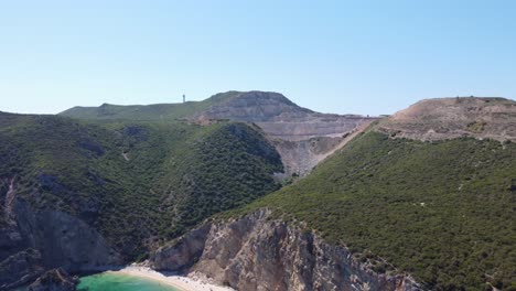 Aerial-Shot-of-a-Beautiful-Portuguese-Cliffside-with-a-Tropical-Beach-below