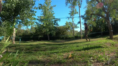 Time-lapse-shot-of-young-woman-learning-slackline-in-natural-park-during-beautiful-sunny-day