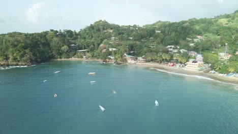 Vista-Aérea-De-Un-Pequeño-Pueblo-De-Pescadores-Con-Barcos-Anclados-En-El-Mar-En-La-Isla-Tropical-De-Tobago
