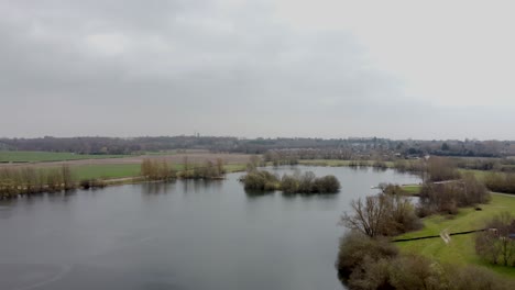 Drone-flight-over-a-pond-on-a-cloudy-day