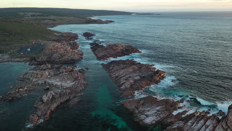 Aerial-view,-Canal-Rocks,-scenic-australian-coastline-and-unique-rock-formation-on-Cape-Naturaliste-and-ocean-waves-in-twilight-after-sunset,-drone-shot