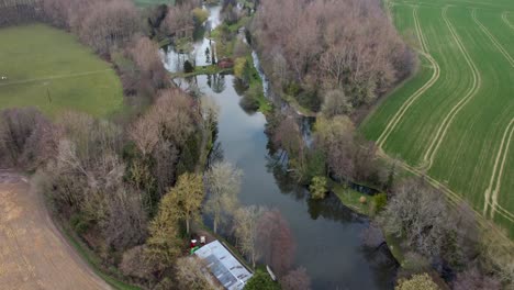 Drones-fly-over-ponds-and-trees-with-fields
