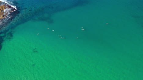 People-swimming-in-the-clear-clear-waters-of-Australia-by-Bondi-Beach---aerial