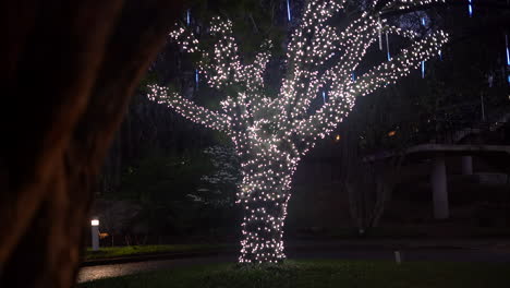 A-beautiful-tree-decorated-with-lights-at-night-for-Christmas,-a-museum,-children's-playground-or-special-event---concept:-perspective,-dream-world,-pandora,-mother-tree,-celebration,-magic