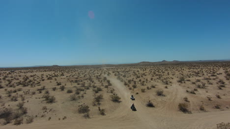 Riding-four-wheelers-in-the-Mojave-Desert's-rugged-terrain-and-harsh-climate---aerial-first-person-view-in-slow-motion