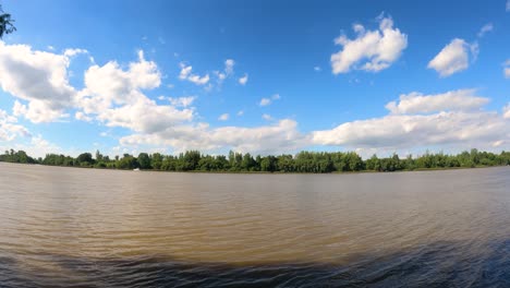 Time-lapse-of-tranquil-Amazon-River-and-clouds-in-motion-against-blue-sky-and-sunlight